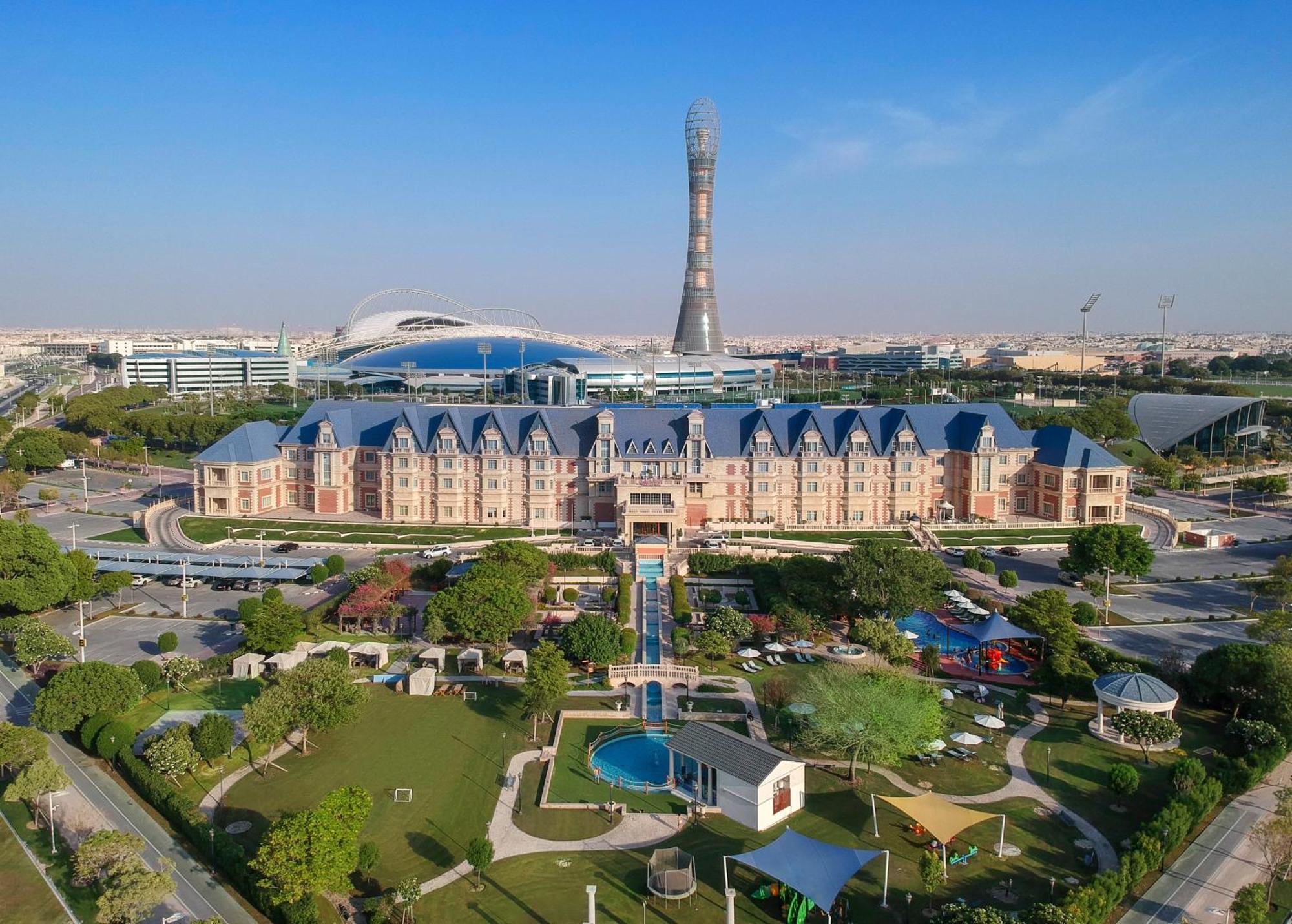 Al Aziziyah Boutique Hotel By The Torch Doha Exterior foto Aerial view of the Al-Shaab Olympic Village